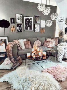 a living room filled with lots of furniture and pictures on the wall above it's coffee table