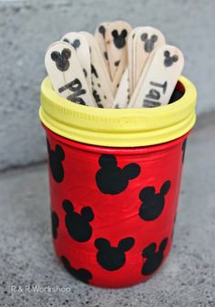 mickey mouse pencils in a red and yellow cup