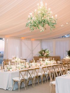 the tables are set with white linens and green centerpieces for an elegant wedding reception