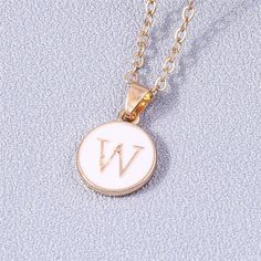 Add a personalized touch to your look with our YourLetter White Enamel Circle Necklace. Crafted with a white enamel background and gold color detailing, the necklace comes with a choice of single letter pendant. A great way to show off your initials or those of someone you love. Gold Initial Pendant Necklace With Letter Print, Minimalist White Jewelry With Initial Pendant, Trendy White Jewelry For Personalized Gift, Personalized Gold Enamel Charm Necklace, Trendy Personalized White Charm Necklaces, Trendy White Letter Jewelry, Trendy White Letter Shaped Jewelry, Trendy White Pendant Charm Necklaces, Trendy White Charm Necklace For Gift