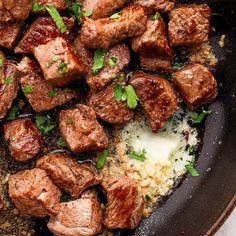 meat and rice in a skillet with parsley on the side, ready to be eaten