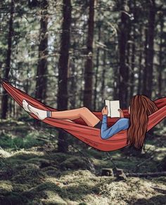 a woman laying in a hammock reading a book