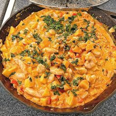 a pan filled with food sitting on top of a table