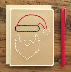 a notepad with a drawing of a man's face wearing a santa hat