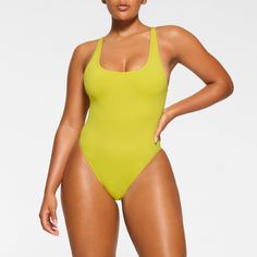 A classic, now elevated. This signature silhouette features deep scoop neck and back, fully adjustable straps, and medium back coverage and is the perfect base to build your swim look. Fits true to size. | SKIMS Scoop Neck One Piece | Yellow | 2XS | Signature Swim Scoop Neck Swimwear With Built-in Bra, Poolside Scoop Neck Swimwear With Adjustable Straps, Scoop Neck Swimwear With Adjustable Straps, Scoop Neck Swimwear With Adjustable Straps For Pool, Scoop Neck Swimwear With Moderate Back Coverage For Sunbathing, Scoop Neck Swimwear For Sunbathing, Solid Seamless Swimwear With Tank Straps, Seamless Swimwear With Wide Straps For Swimming, Seamless Swimwear With Wide Straps