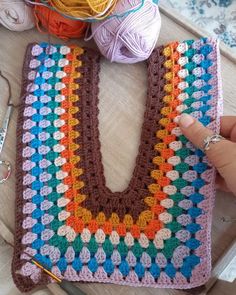 a crochet granny bag is being worked on