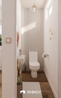 a bathroom with white walls and wooden flooring