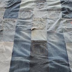 a quilt made out of jeans on top of a bed