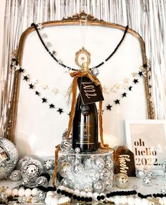 a bottle of champagne sitting on top of a table next to other decorations and ornaments