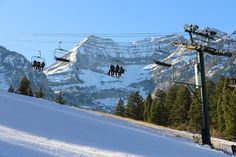 the ski lift is carrying skiers down the mountain