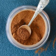 a spoon in a container filled with brown powder