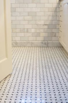 a bathroom with white and blue tile flooring