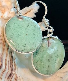 These are Gorgeous, Chrysoprase Round Shaped Earrings that are sure to be an Eye Catcher! The Colors are Beautiful Shades of Seafoam Greens.  Set in a .925 Sterling Silver Framed Edge. The Earrings, Including the .925 Sterling Silver Hooks, are 1 1/2" Long.  The Stones Measure 3/4"  X  3/4" Wide. Marked 925 6.6 Grams Total Weight. Gift Boxed. Chrysoprase, or Chrysophrase  is a gemstone variety of chalcedony  that contains small quantities of nickel. Its color is normally apple-green, but varies Round Chrysoprase Earrings Gift, Earrings Green, Seafoam Green, New Love, Silver Frame, Deep Green, Sea Foam, Gemstone Earrings, Favorite Jewelry