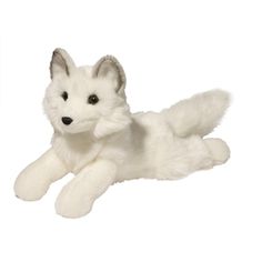 a white stuffed fox laying down on the ground with it's eyes wide open