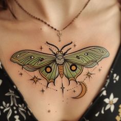 a woman's chest with a green butterfly tattoo on the top of her stomach