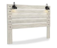 a white wooden headboard with two lights on it