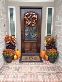 two pumpkins are sitting in front of a door