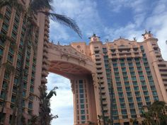 a large building with palm trees in front of it