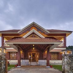 the entrance to a large home with stone walls