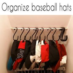 an organized baseball hat rack in the corner of a room