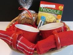 a basket with two cups and some food in it