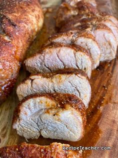 sliced pork is sitting on a cutting board