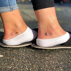 two people with small tattoos on their feet and one has a sun and moon tattoo