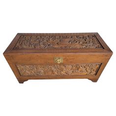 an old wooden box with carvings on the lid and handles, sitting against a white background