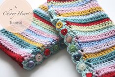 two crocheted hand warmers with buttons on each side and the words, lacy heart