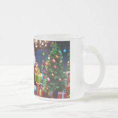 a coffee mug with a christmas tree and presents on it