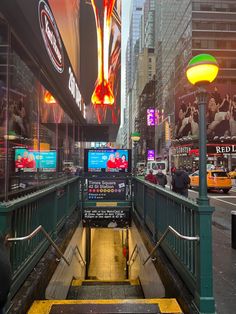 an escalator in the middle of a busy city street