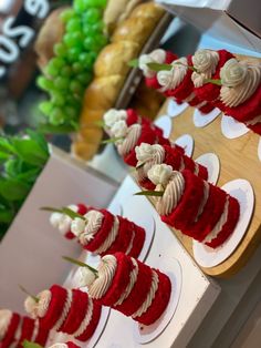 several red and white cakes are on display