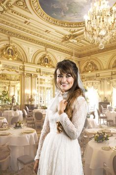 a woman in a wedding dress posing for the camera