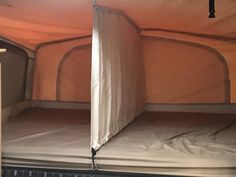 the inside of a tent with two mattresses