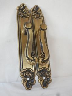 an ornate brass door handle on a white background