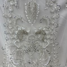 the back of a wedding dress with beading and sequins