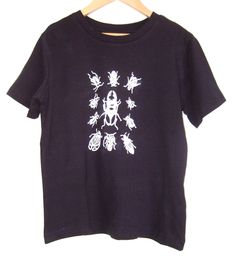 Love Bugs- kids hand printed t shirt dark navy blue organic cotton , white beetles and bugs print   Childrens Age 5-6 years (small sizing) EU 110-116 classic style childrens T shirt chest width 36cm, length 46cm  Gift for kids who love creepy crawlies one off print Eco T shirt 100% organic cotton 155g  Earth Positive Climate Neutral manufacture, Fair Wear Hand screen printed by us at the studio Water based fabric inks  Eco wash 30' Line dry Design and Printed in London More  kids tees- sizes, st Bug Print, Positive Tees, Insect Print, Eco Fabric, Bamboo Clothing, Beetles, Dark Navy Blue, Kid Tees, Kids Tops