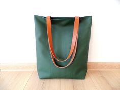 Large everyday casual vegan leather tote bag in forest green color with real leather handles. * Exterior: - High quality vegan/faux leather in beautiful intense dark green  color. * Interior: - Sandy beige ad white polka dot Italian natural cotton. * Two inside slip pockets for personal belongings like phone, keys, etc. * Real leather handles in dark chocolate brown/cognac brown/black attached with antique toned brass rivets * Closes with magnetic snap closure reinforced with natural leather * A Green Tote Bag With Leather Handles, Green Canvas Bag With Leather Handles For On-the-go, Green Hobo Bag With Leather Handles For On-the-go, Eco-friendly Green Bag With Leather Handles, Green Leather Hobo Bag With Gold-tone Hardware, Vegan Leather Tote Bag, Casual Tote Bag, Forest Green Color, Dark Chocolate Brown