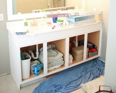 there is a bathroom vanity with many items on it