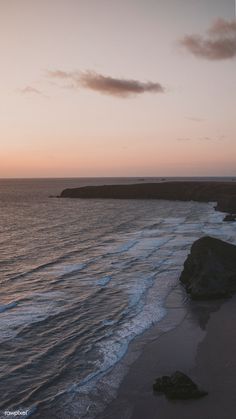 the sun is setting over the ocean and beach