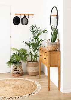 an image of a room with potted plants on the table and other items in baskets