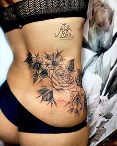 a woman with a flower tattoo on her stomach