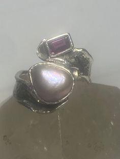 "Pearl ring garnet band Lulu boho sterling silver women Size 8 Weight 8.1g Length 3/4\" Width 1/2\" Thinnest part 1/4\" Free Shipping & Free Postal Insurance Delivered in a Gift Box If you do not want the ring polished and want to leave the natural patina please let me know at the time of purchase as I do polish rings before I ship rings out. Thanks Free First Class shipping and postal insurance is included. If you want to upgrade to priority kindly pay an additional fee to do so. This is recomm Elegant Silver Stackable Ruby Ring, Unique Stackable Open Band Jewelry, Elegant Silver Stackable Rings With Natural Stones, Unique Open Band Sterling Silver Jewelry, Silver Jewelry With Ethical Gemstones In Open Band, Unique Stackable Open Ring Jewelry, Silver Sterling Stackable Rings With Natural Stones, Silver Gemstone Stackable Rings Fine Jewelry, Fine Jewelry Silver Gemstone Stackable Rings