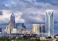 the city is full of tall buildings and skyscrapers in the distance, with trees on either side