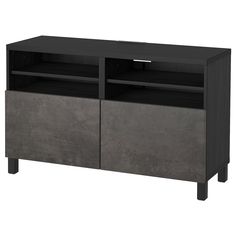 an entertainment center with two doors and one shelf on the bottom, in dark grey concrete