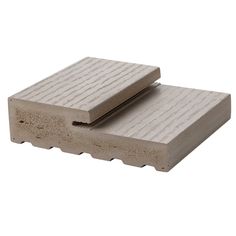 two pieces of concrete sitting on top of each other in front of a white background