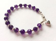 Rich, deep purple faceted amethysts with sterling silver beads and a sterling silver heart charm create a luxury bracelet.  The amethysts are of beautiful clarity and pure violet purple colour.  Amethyst is the birthstone of Aquarius, those born in February. A stunning bracelet, perfect as a special gift. Classy and elegant! Amethyst is called the 'All Healer' of gemstones, because of its soothing and healing properties! Length 19cm. Only one available.  Unique hand made bracelet with original d Purple Gemstone Beaded Bracelets In Sterling Silver, Silver Amethyst Beaded Bracelets With Faceted Beads, Silver Amethyst Beaded Bracelet With Faceted Beads, Faceted Purple Amethyst Beaded Bracelets, Purple Amethyst Faceted Beaded Bracelets, Purple Faceted Amethyst Beaded Bracelets, Purple Amethyst Charm Bracelet For Gift, Purple Amethyst Charm Bracelet Gift, Spiritual Sterling Silver Bracelet With Purple Gemstone