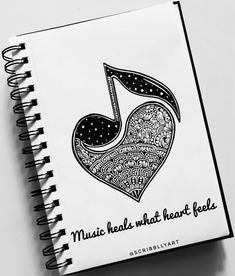 a spiral notebook with music heals what heart feels