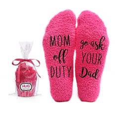 pink slippers with i'm not the boss written on them next to a bag