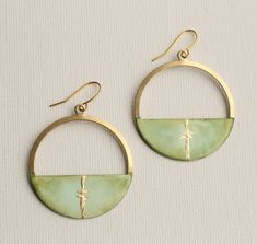 These beautiful and unique kintsugi hoop earrings have been made by hand enamelling and carefully blending shades of light, soft olive green.  The centre of the hoop has a fine seam of genuine gold leaf, to create a delicate impression of kintsugi.   Kintsugi is the Japanese art of using gold to mend what was broken, to highlight and transform imperfections or flaws into a point of beauty.   We have added a high quality gold plated brass earwires. The earrings measure 5cm (two inches) long, and the hoop is designed to hang just below the earlobe.  Each pair is handmade and no two pieces are quite the same! Have a look at the other enamel designs in my shop!  https://www.etsy.com/uk/shop/SilkPurseSowsEar?ref=hdr_shop_menu&search_query=enamel This piece of handmade jewellery comes packaged i Japanese Earrings, Green Hoop Earrings, Kintsugi Art, Japanese Jewelry, Silk Purse, Broken China Jewelry, China Jewelry, Broken China, Handmade Jewellery